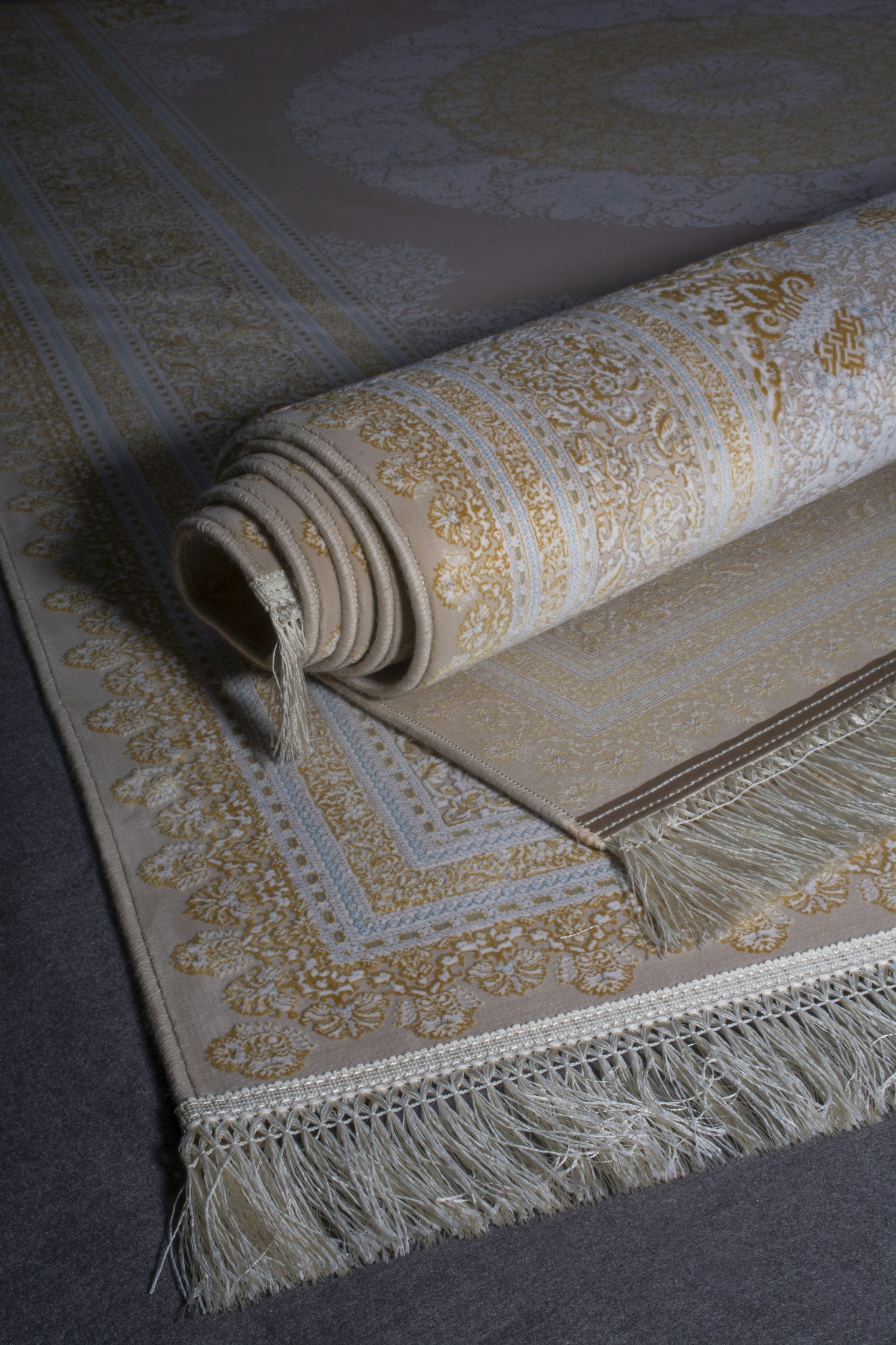 Close-up of a hand-knotted rug showing fringe and dense pile, the traditional craft practiced in Bhadohi